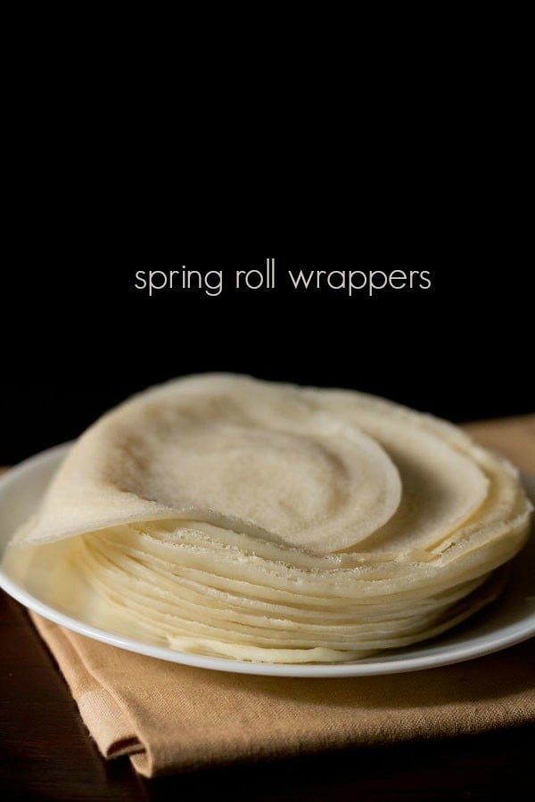 spring roll wrappers placed on a white plate with text layover.