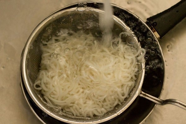 rinsing noodles under cold water