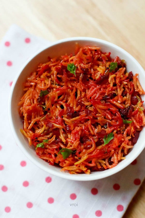 beetroot rice garnished with coriander leaves and served in a white bowl. 