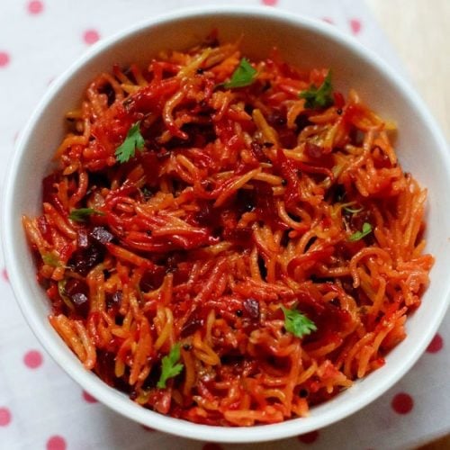 beetroot rice garnished with coriander leaves and served in a white bowl.