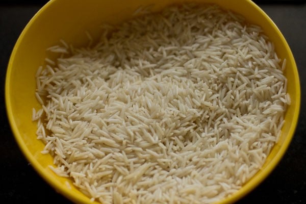 basmati rice in a yellow bowl for making beetroot rice recipe.