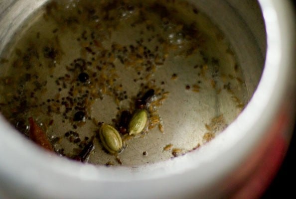 frying spices in hot oil for making beetroot rice. 