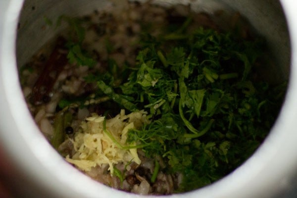 ginger-garlic paste, slit green chilies and chopped coriander leaves added to the onions. 