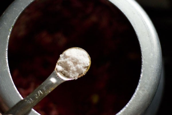 adding salt to the beetroot rice. 