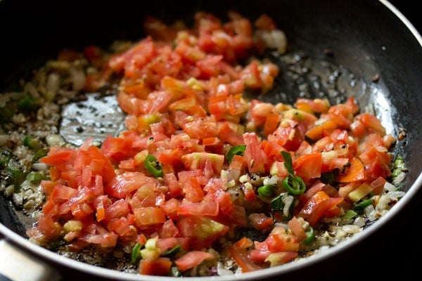 chopped tomatoes added to pan