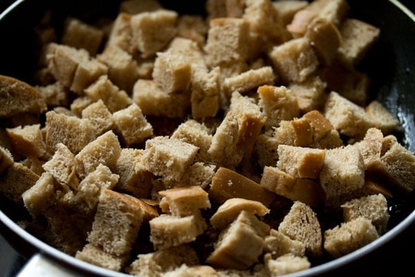 bread cubes added on top of onion-tomato-spices mixture