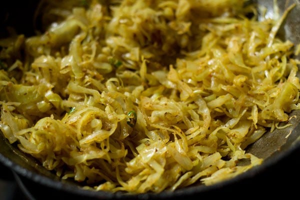 mixing spices with cabbage