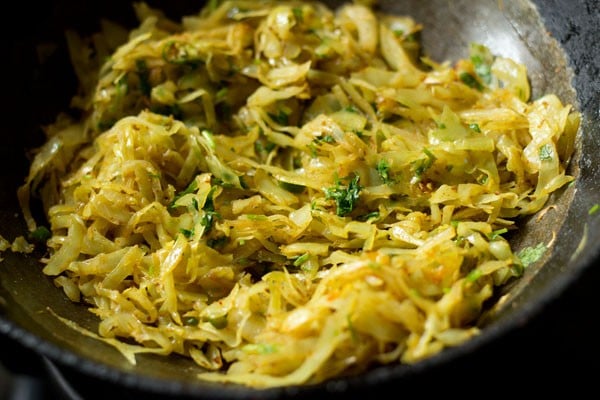 mixing coriander leaves with cabbage stuffing
