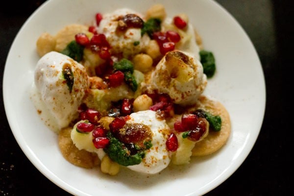 red chili powder, roasted cumin powder, chaat masala powder, black salt and fresh pomegranate arils sprinkled on dahi bhalla. 