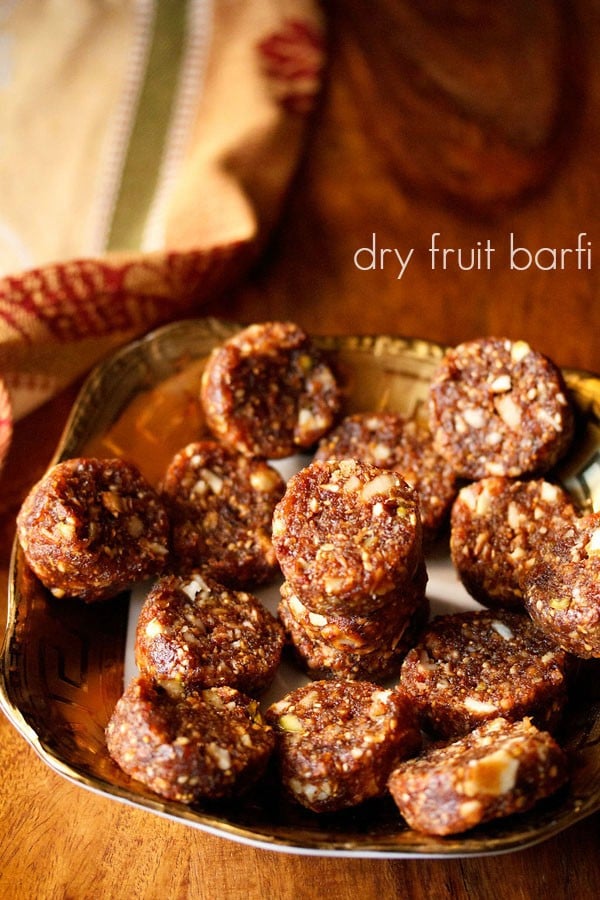 dry fruit barfi on a plate with text layovers.