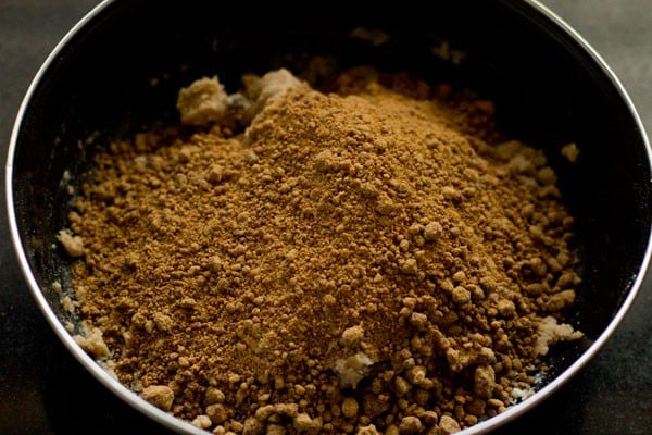 powdered jaggery added to the flour mixture in the bowl. 