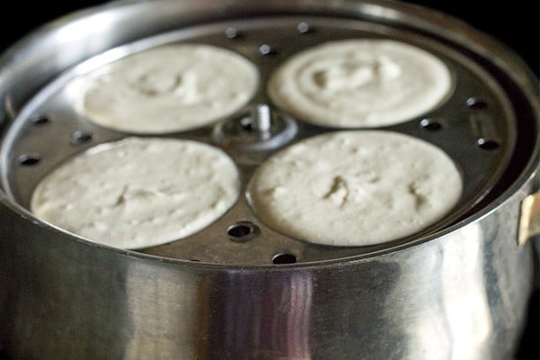 idli stand filled with batter and placed in a steamer. 