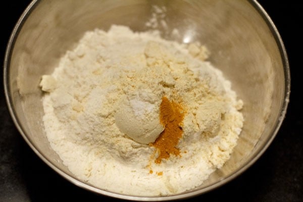dry ingredients for jalebi batter added to mixing bowl
