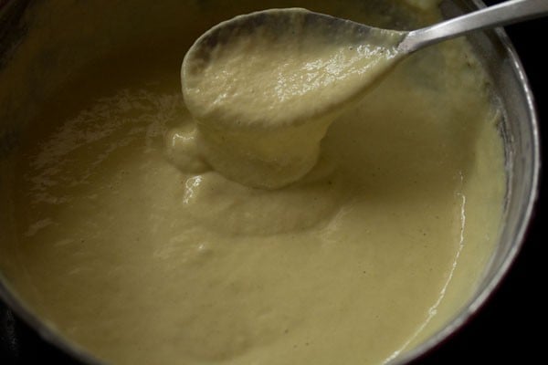 spoon showing consistency for batter after adding flour