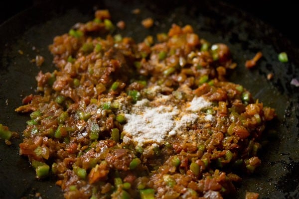 salt added to the onion-tomato-capsicum mixture. 