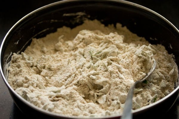 mixing flour with fenugreek leaves and spices