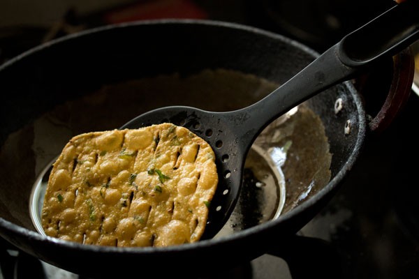 frying methi puri till crisp and golden