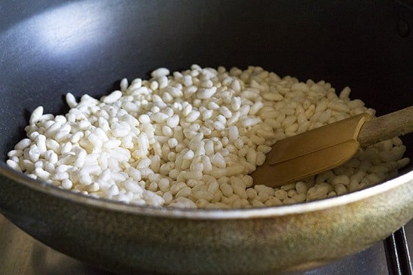 roasting puffed rice for making pori urundai. 