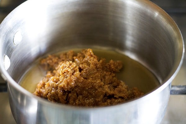 grated jaggery and water added to another pan. 