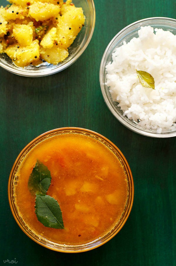 pineapple rasam served in a bowl with steamed rice and sabzi