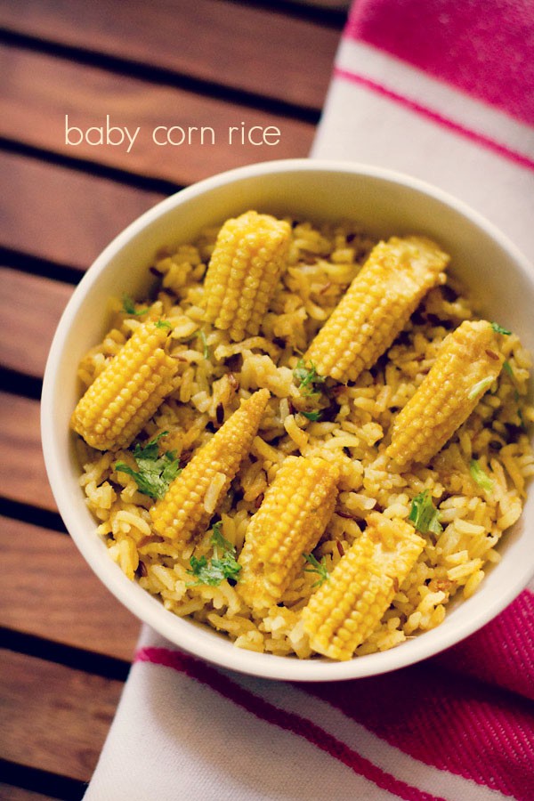 baby corn rice garnished with coriander leaves and served in a white bowl.