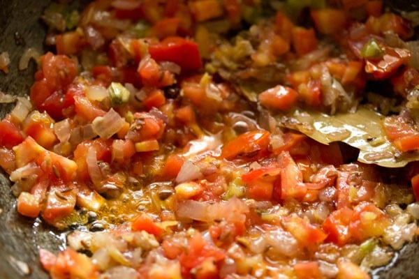 mixing tomatoes with the mixture