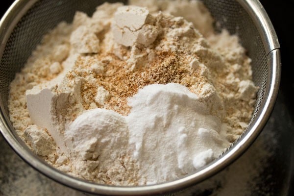 flours and ground spices in a sieve