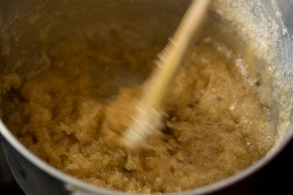 sugar syrup being stirred with a wooden spatula - it looks a bit grainy at this stage
