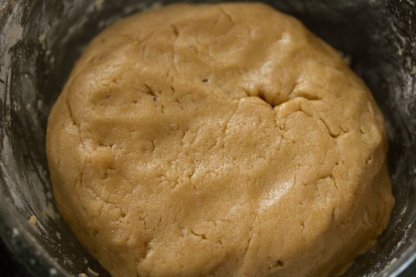 completed dough of eggless gingerbread cookies recipe in a clear bowl.