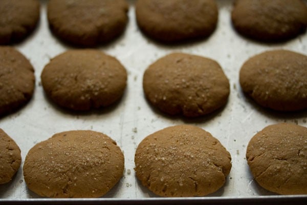 baked eggless gingerbread cookies on a sheet pan.