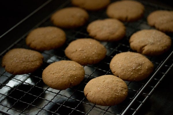 eggless gingerbread cookies cooling on a rack after baking.