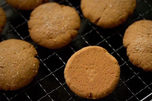 showing the golden underside of a baked cookie on a cooling rack.
