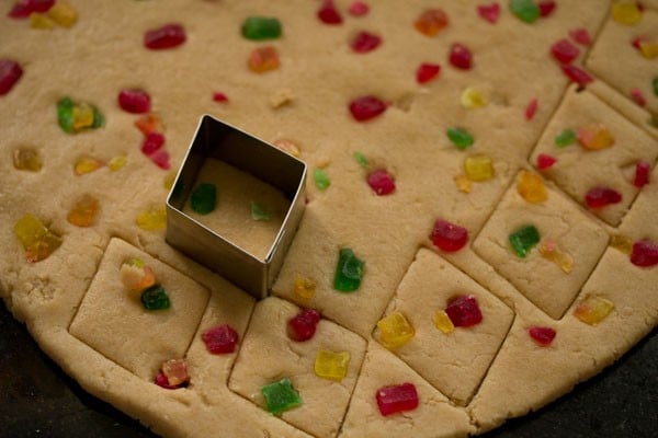 cutting out cookies from the dough using a biscuit cutter. 