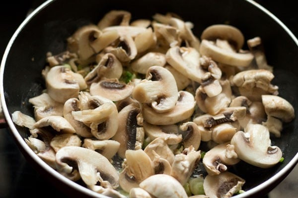 sliced mushrooms added to the wok. 