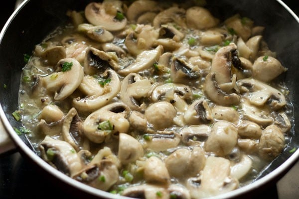 sautéing mushrooms in the wok. 