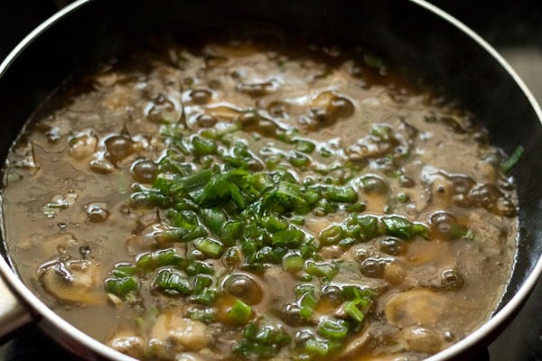 chopped spring onion greens, rice vinegar and rice wine added to the mushrooms. 