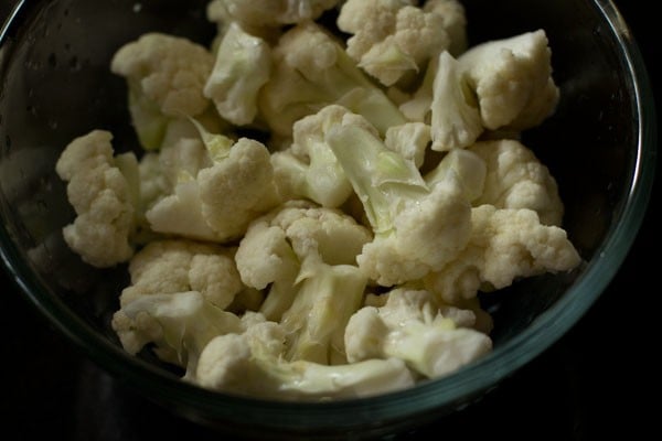 chopped cauliflower florets in a glass bowl