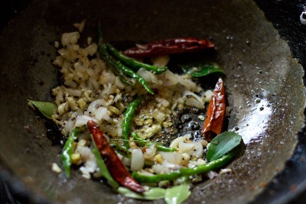 tempering mixture with onions being sautéed in oil