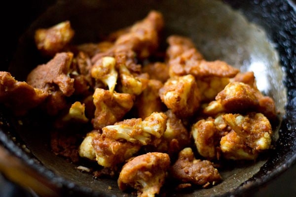 fried cauliflower added to tempering mixture in pan