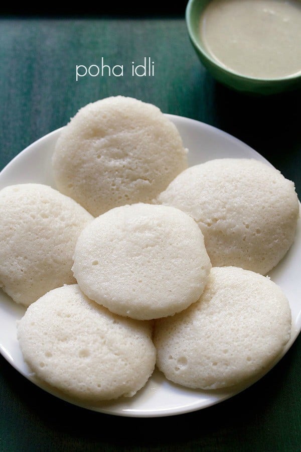 poha idli served on a white plate.