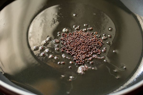 crackling mustard seeds in a hot skillet