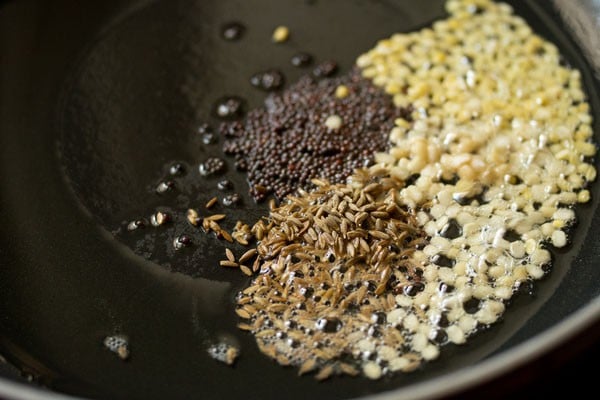 frying lentils and spices in a skillet