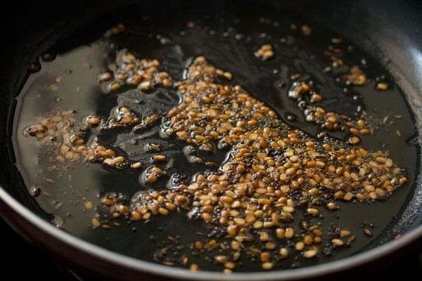 frying dal and spices in a skillet
