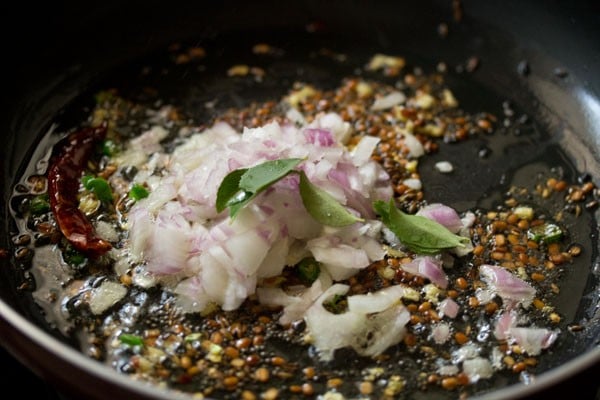 chopped onions and curry leaves added to the skillet