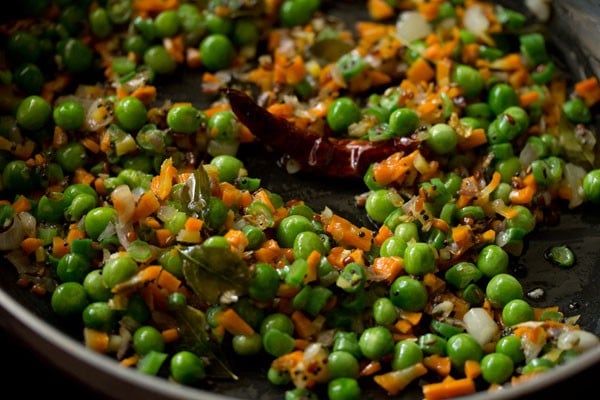 mixing veggies in pan