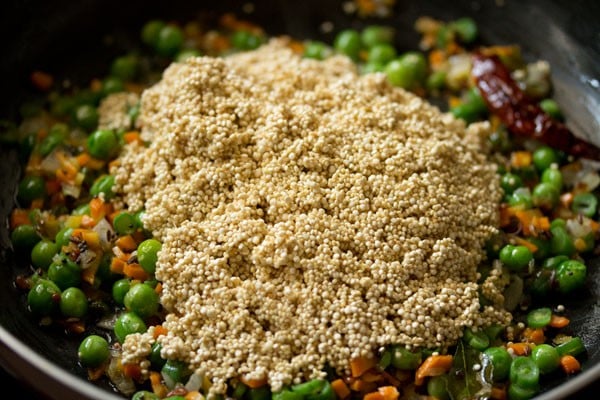 quinoa in pan on top of mix vegetable mixture