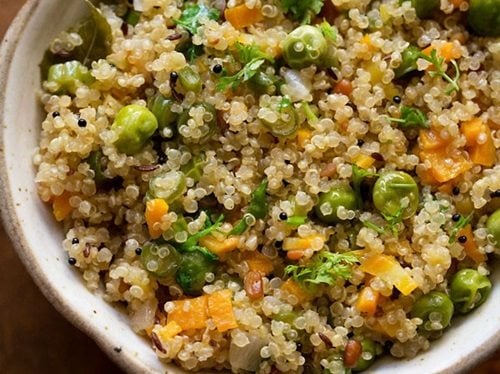 closeup shot of quinoa upma in a ceramic bowl