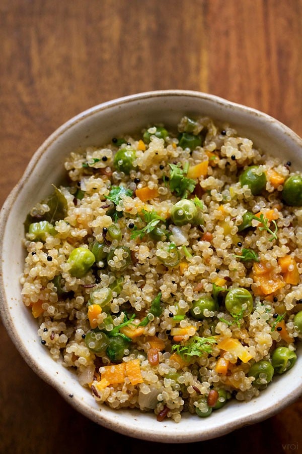 closeup shot of quinoa upma in a ceramic bowl