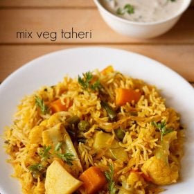 vegetable tehri served on a white plate with a small bowl of raita kept on the top right side and text layovers.