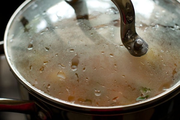 cooking vegetable rice in a covered pan. 